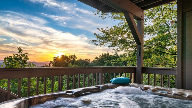 A hot tub with a wooden deck and a view of the sunset. - Incredible Views! Massage Chairs, Hot-tub, WiFi (Gatlinburg)