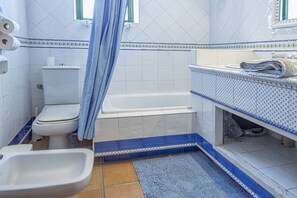 Bathtub, hair dryer, towels