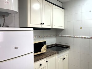 Fridge, microwave, coffee/tea maker, cookware/dishes/utensils