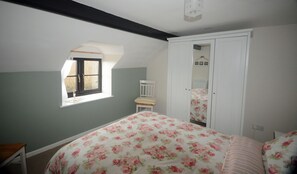 A bedroom with a bed, a window, a chair, and a wardrobe. - Beautiful and Quiet Rural hideaway for two near Ludlow with stunning views (Knowbury)