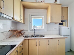 Fridge, microwave, coffee/tea maker, cookware/dishes/utensils