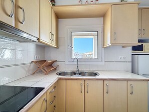 Fridge, microwave, coffee/tea maker, cookware/dishes/utensils