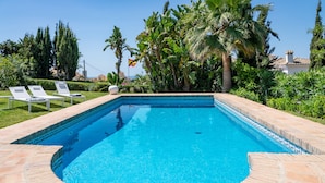 A rectangular swimming pool with a tiled edge, surrounded by a stone deck. -  Beautiful sunny villa with pool and sea views Marbella (ELVIRIA) (Marbella)