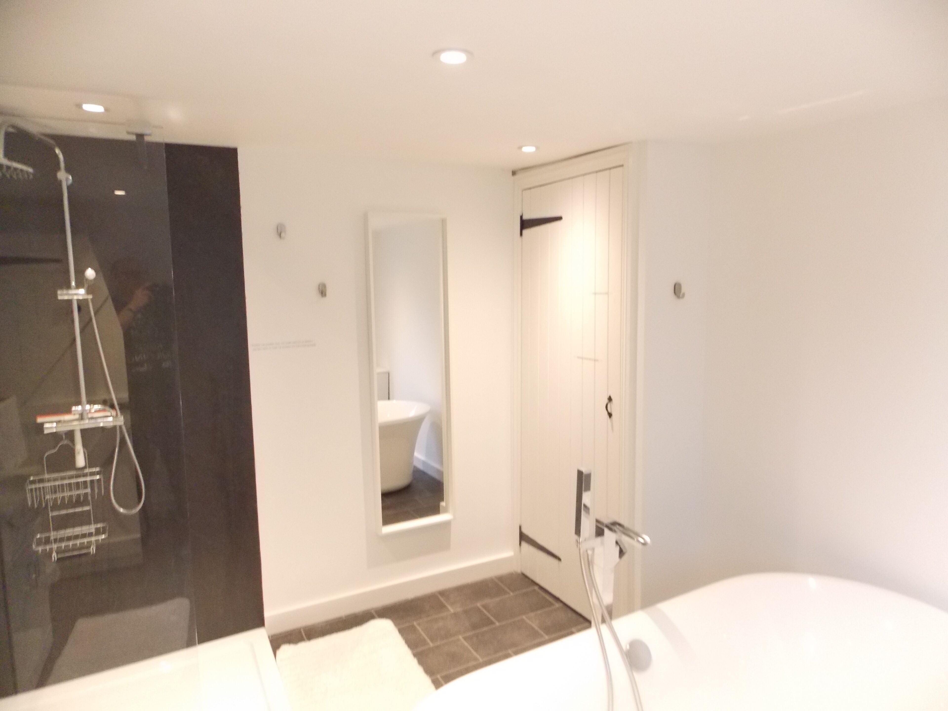 Bathtub, hair dryer, towels, toilet paper