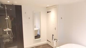 Bathtub, hair dryer, towels, toilet paper