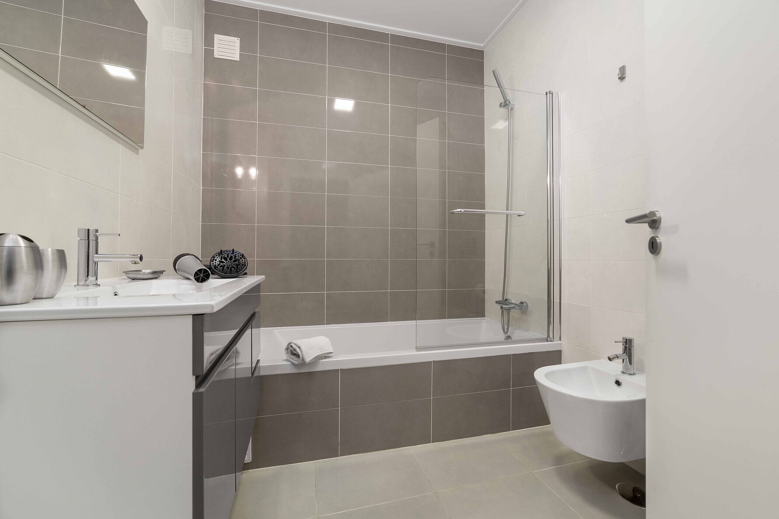 Une salle de bain moderne avec une baignoire, une douche et un lavabo.