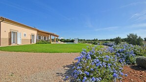 Ein Gebäude mit überdachter Terrasse und Swimmingpool.
