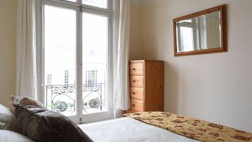 1 bedroom, desk, iron/ironing board, travel crib