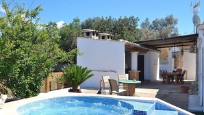 A swimming pool with a hot tub, surrounded by a patio area with outdoor furniture and a pergola. - Can Butxaquí 160 fantastic villa with private pool and jacuzzi, air conditioning, barbecue and WiFi (Muro)