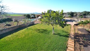 A well-maintained lawn with a tree, a swimming pool, and a house with a patio. - Sa Rota 078 fantastic finca with private pool, garden, ping pong and fibre optics (Ariany)