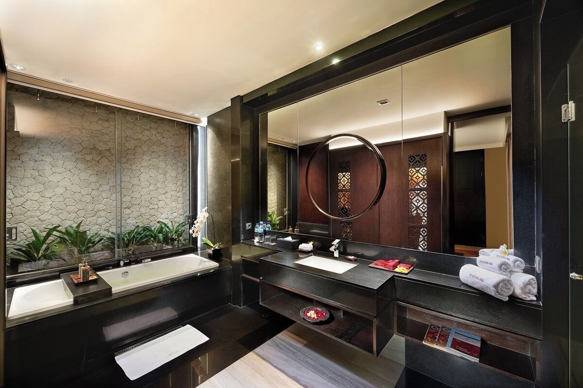 A modern bathroom with two sinks, a large mirror, and a towel rack.