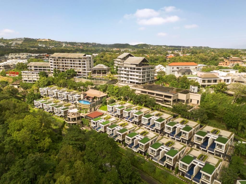 A residential area with multiple apartment buildings, some with green roofs, and a swimming pool.