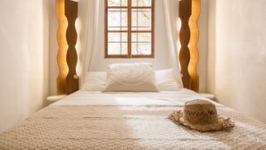 A bedroom with a bed, a window, and a hat on the bed. - Finca Son Grauet - Spectacular villa with pool in Llucmajor (LLucmajor)