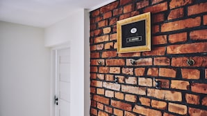 A brick wall with a framed plaque reading "A.J. JAGOWIE." - Irena and Anatol Apartment - 5 min walk to Krakow’s Main Square! Sleeps 4!  (Kraków)