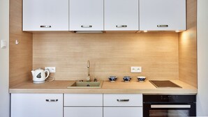 A modern kitchen with white cabinets, a stainless steel kettle, a sink, and a dishwasher. - Irena and Anatol Apartment - 5 min walk to Krakow’s Main Square! Sleeps 4!  (Krak ów)