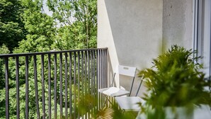 A balcony with a metal railing, a small white table, and chairs. - Irena and Anatol Apartment - 5 min walk to Krakow’s Main Square! Sleeps 4!  (Kraków)