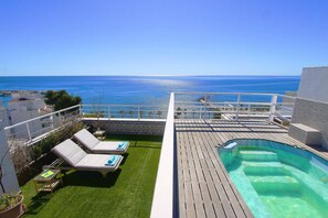A rooftop pool area with lounge chairs and a view of the sea. - 1149 Stunning Duplex Penthouse with Panoramic Sea Views (Marbella)