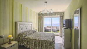 A bedroom with a bed, a TV, a nightstand, and a view of the outdoors. - 1149 Stunning Duplex Penthouse with Panoramic Sea Views (Marbella)