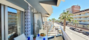 A balcony with a view of a street, palm trees, and a building labeled "HOTEL PANORAMA." - Rocamaura IV-2-9 Rent apartment on the Costa Brava in L'Estartit (Estartit)