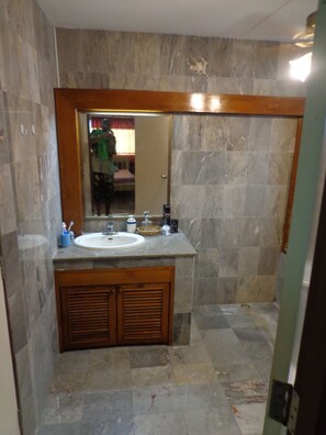 Een bad/douchecombinatie, een haardroger, een bidet, handdoeken