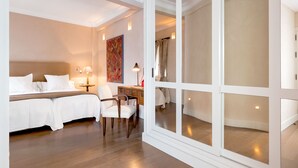 A hotel room with a large bed, a desk, and a chair. There is a window with a view of the outside. - Genteel Home Contratacion (Seville)