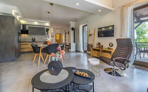 Un espacio moderno para vivir con cocina, comedor y zona de estar con una silla y una mesa.