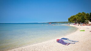 Relax on the beach with calm waters and scenic views.