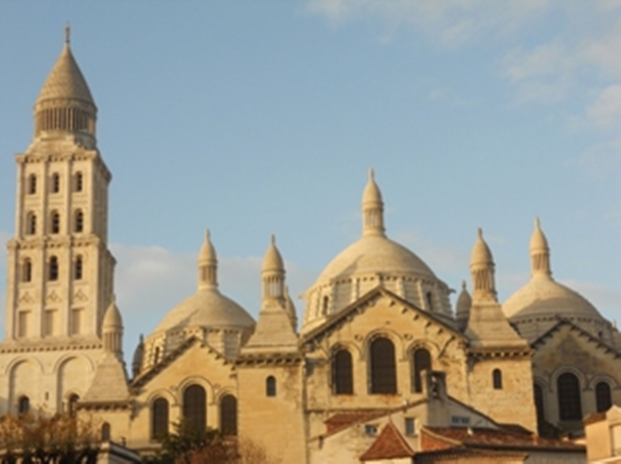 A historic building with multiple domes and a tall tower.