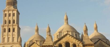 A historic building with multiple domes and a tall tower.