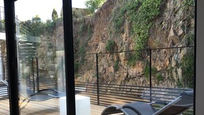 A balcony with a wooden floor, metal railings, and two lounge chairs. - Villa Grand Standing 170m2 :4*, Pool & Jacuzzi PRIVATE: 5 Mn from the beaches (Perros-Guirec)