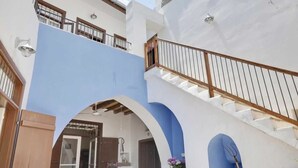 A multi-level building with a blue and white color scheme, featuring balconies and a staircase. - Lefkara View (Pano Lefkara)