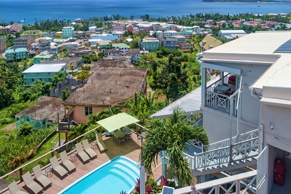 View from above the hotel toward the pool below, the caribbean sea + Cabrits