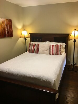 A neatly made bed with white bedding, two bedside lamps, and striped pillows. - Luxury condo, walking distance to Lionshead Gondola 4B  & 4B premier partner (Vail)