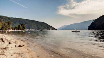 Surrounded by serene lakeside views, this tranquil setting offers a peaceful escape with a clear sky and calm water.