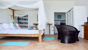 A bedroom with a bed, a desk, a chair, and a bookshelf.
