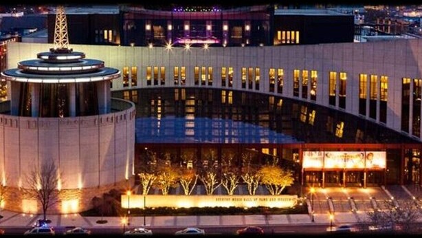 A modern building with a circular central feature, large windows, and a well-lit entrance area.