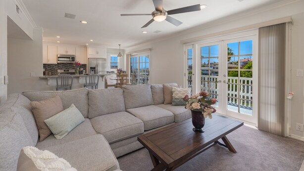 A spacious living room with a large sofa, a coffee table, and a ceiling fan. - Great Lantern District Location!.. Central AC!...Ocean View<br> (Dana Point)
