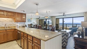 A spacious kitchen with granite countertops, wooden cabinets, and pendant lighting. - 202- Offers AMAZING GULF VIEWS from private balcony. Destin Beach Club (Destin)