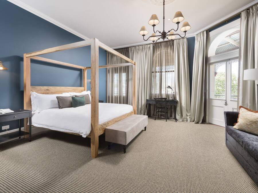 Deluxe Suite, 1 King Bed, Balcony | Premium bedding, minibar, in-room safe, individually decorated