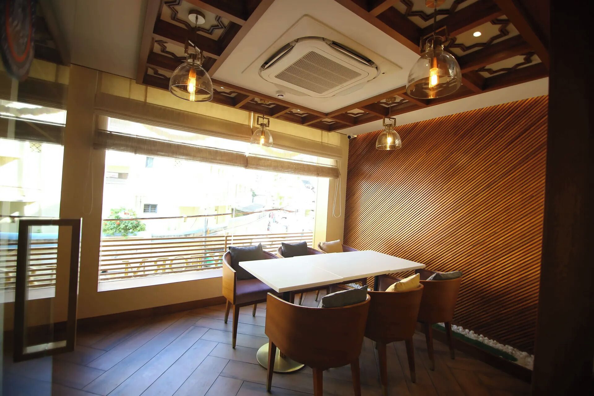 A dining area with a table, chairs, and a ceiling with a central air vent.