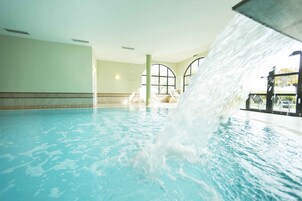 A swimming pool with a water feature.