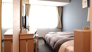 A hotel room with a bed, a desk, and a chair. There is a window with curtains and a picture on the wall. - FUN GATE HOTEL SAPPORO (Sapporo)