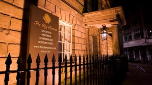 A building facade with a sign for The City Rooms, listing services like ballroom, weddings, and conferences. - The City Rooms (Leicester)