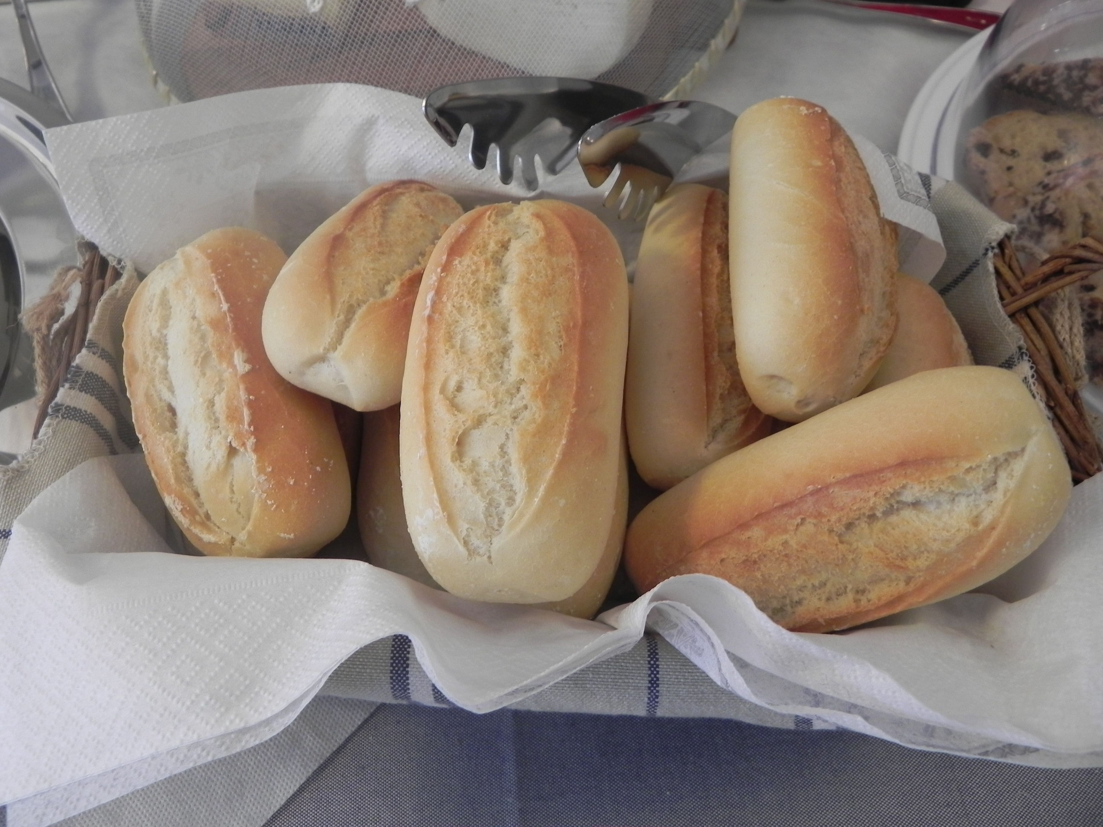 A basket of freshly baked bread rolls.