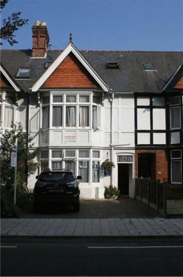 Traditional home with a pitched roof and large windows, offering ample natural light.