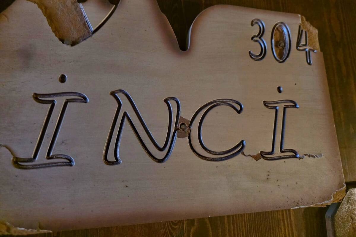 Un senyal de fusta amb el número 304 i el nom 'INCI' gravat.