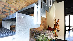 A brick wall, a metal structure, and a decorative horse statue.