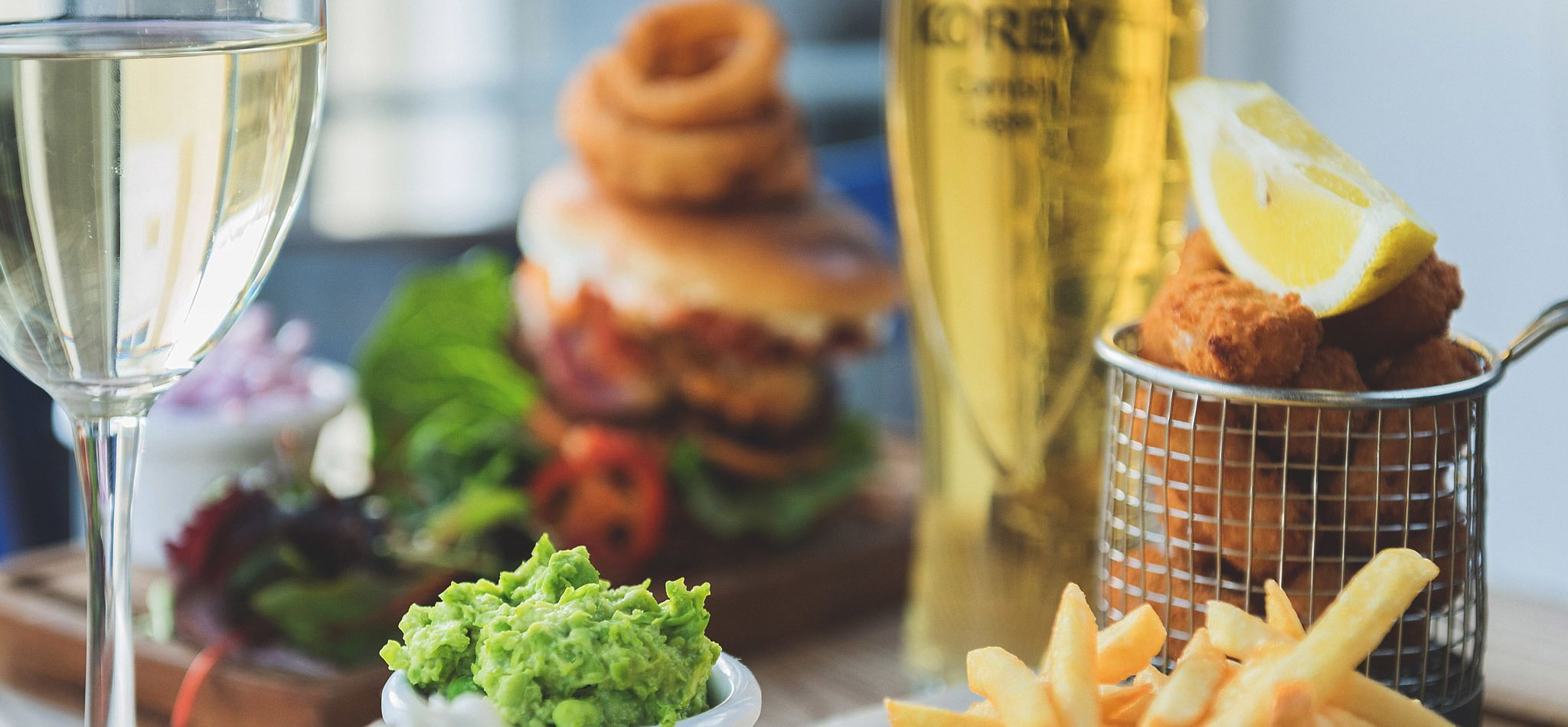 A meal with a burger, fries, and a drink.