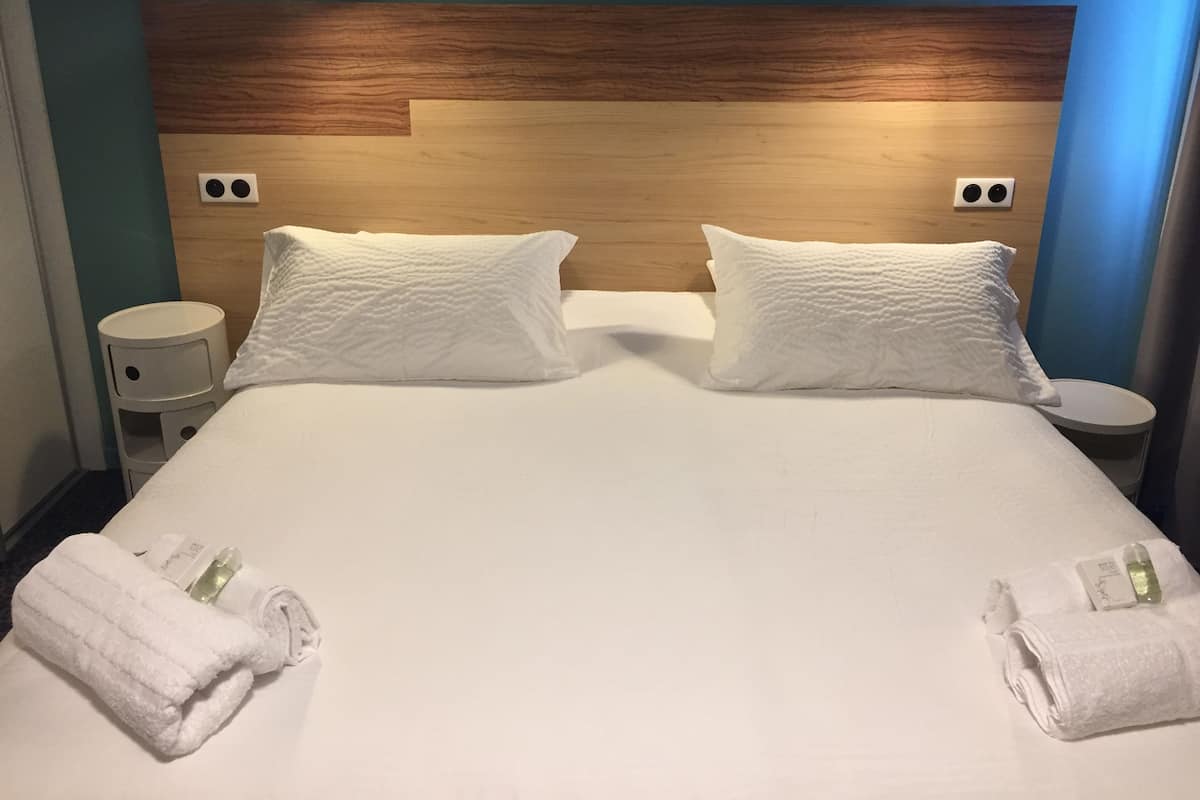 Ropa de cama de alta calidad y caja de seguridad en la habitación