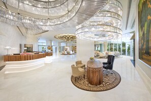 A spacious lobby with a reception desk, seating area, and a large chandelier. - ITC Kohenur, a Luxury Collection Hotel, Hyderabad (Hyderabad)